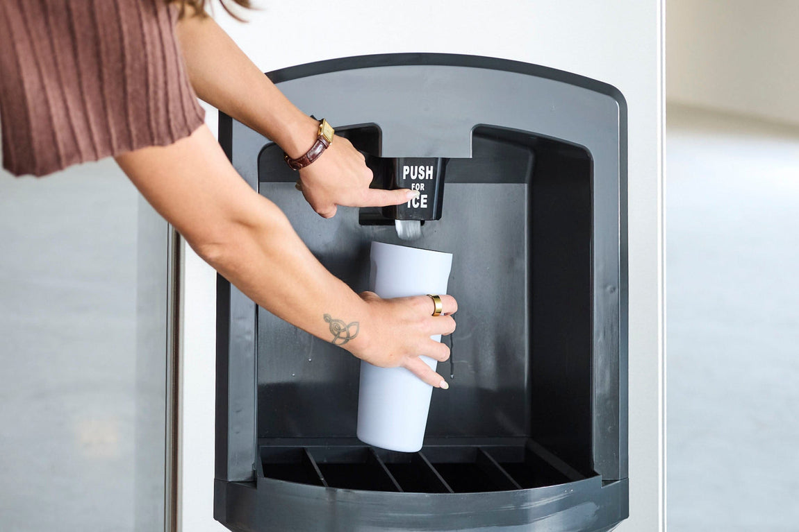 A person filling a cup at a Bottleless Nation water dispenser